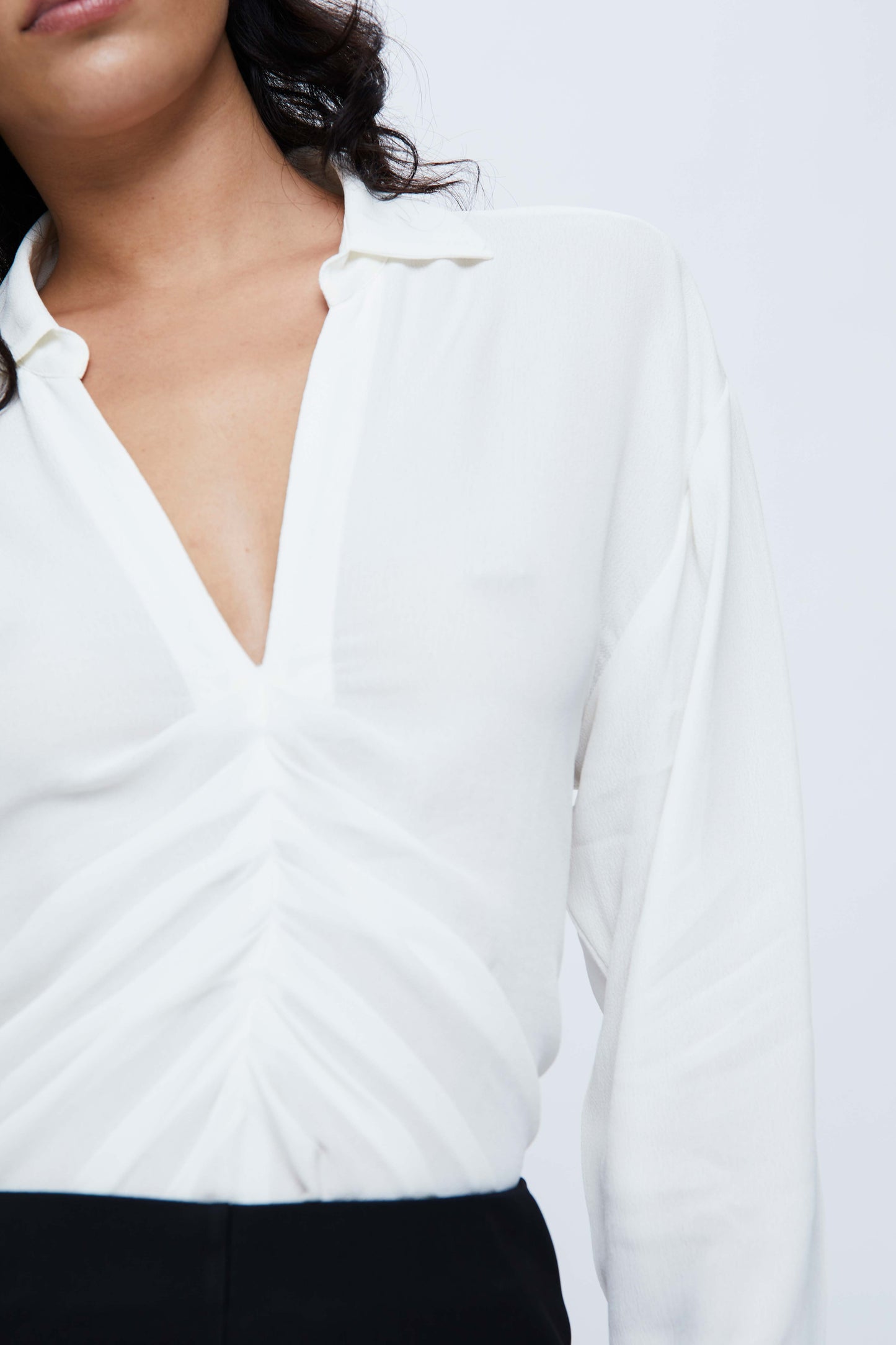 White draped shirt with V-neckline