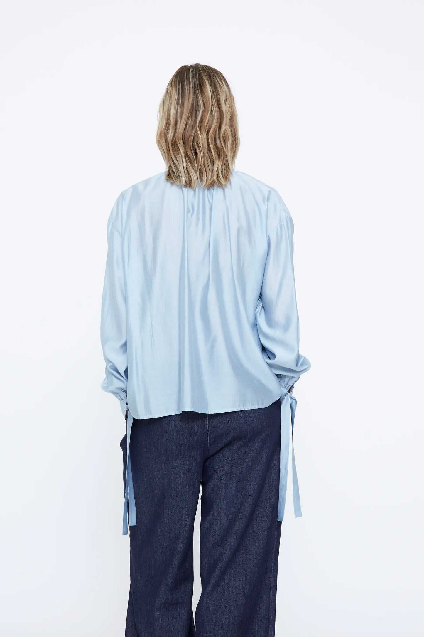 Camisa de saten azul claro con detalle lazado